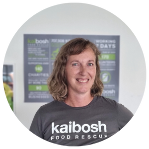 Head and shoulder photo of a smiling woman wearing a Kaibosh t-shirt.